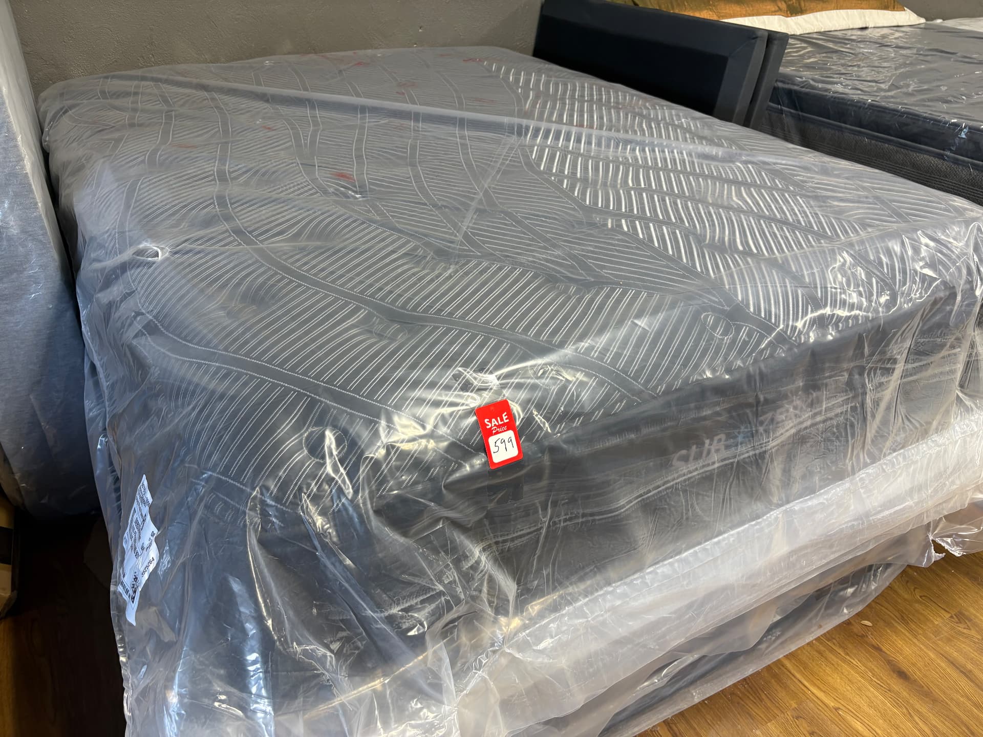Striped-top mattress displayed on the showroom floor