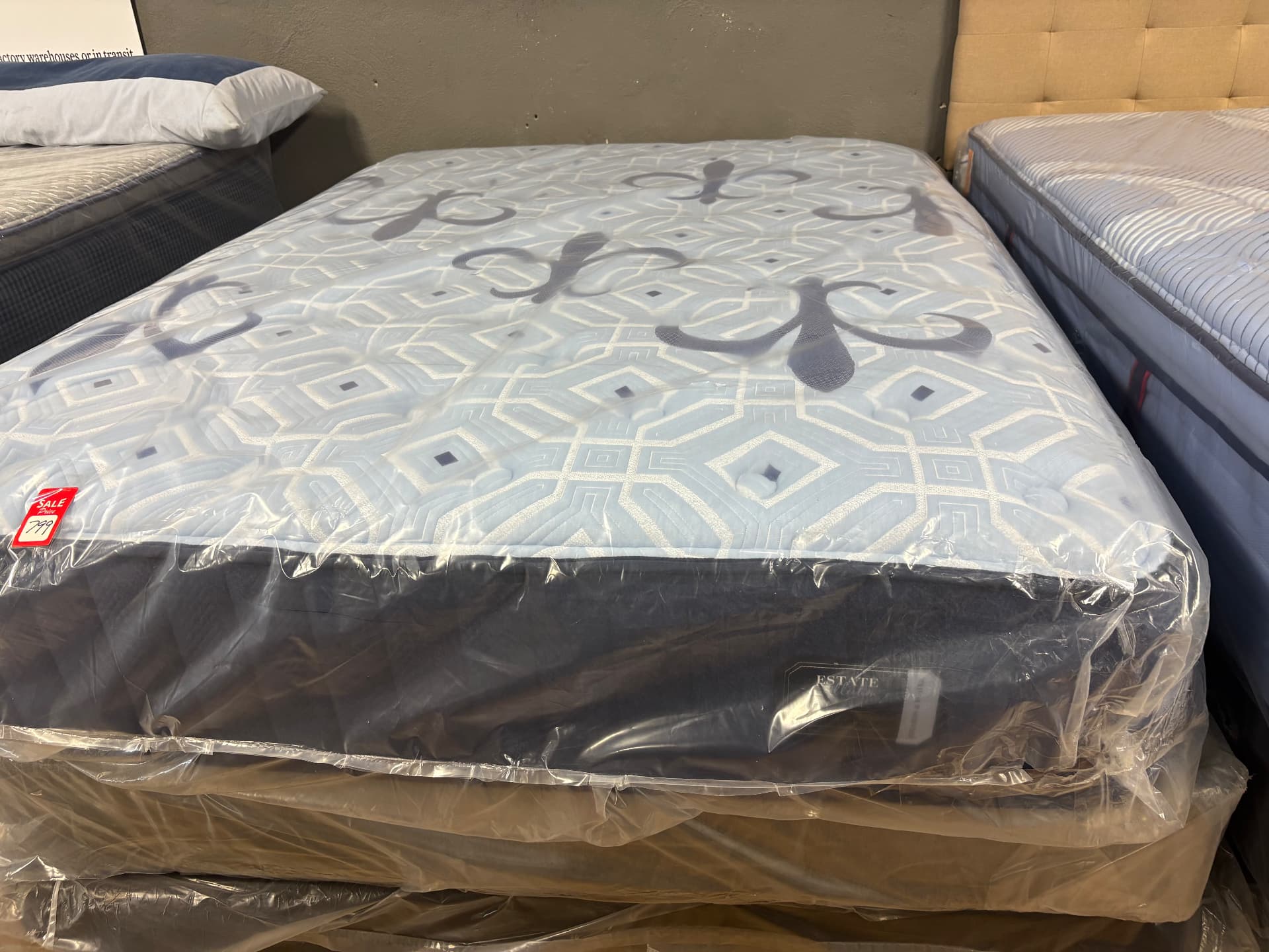 Mattress with a geometric top pattern displayed between mattresses
