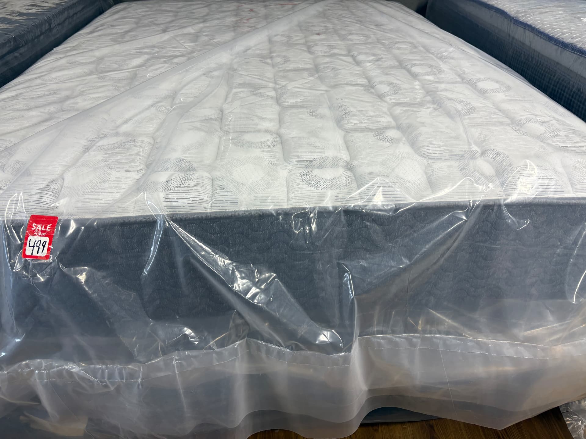 Light-topped mattress in clear protective wrapping